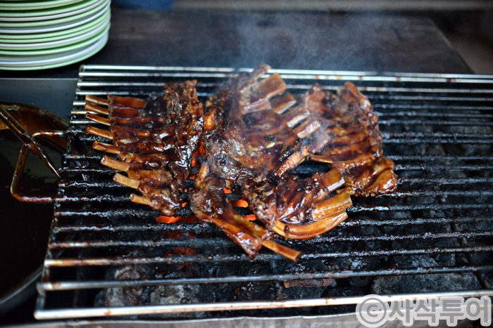 Ribs cooking over charcoal