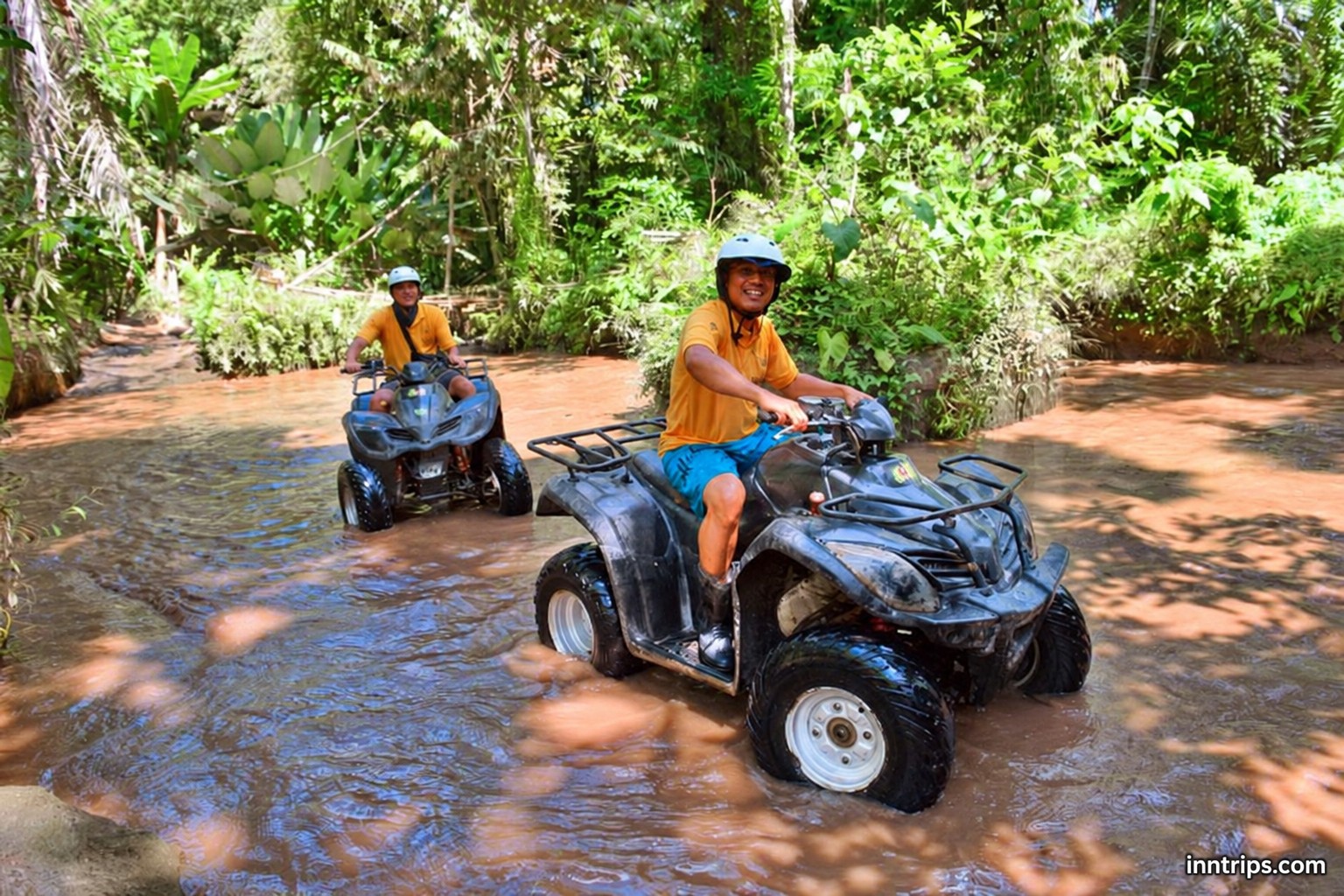 ATV riding through a jungle water crossing
